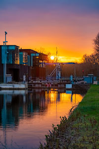 Scenic view of river against sky during sunset