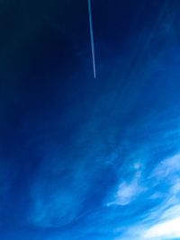 Low angle view of vapor trail in blue sky