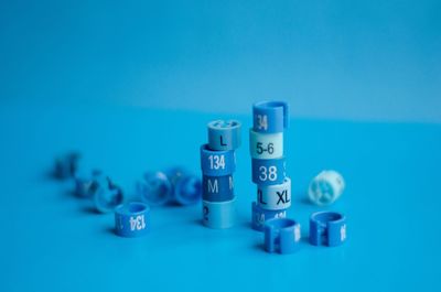 Close-up of coins on table against blue background