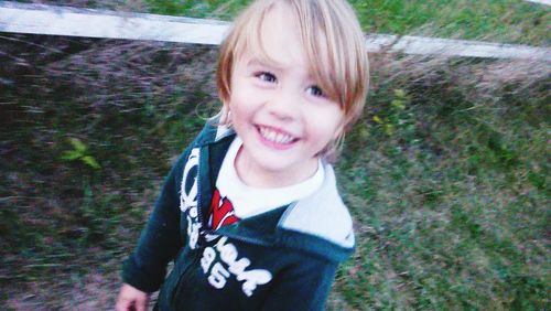 Portrait of smiling girl standing outdoors