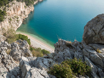 High angle view of rocks by sea