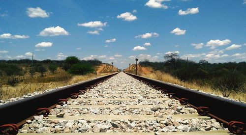 Surface level of railroad tracks against sky