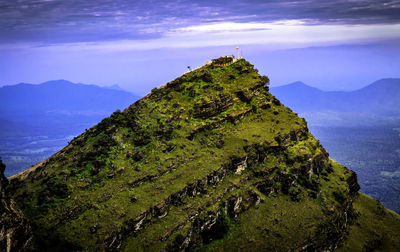 Scenic view of mountains against blue sky