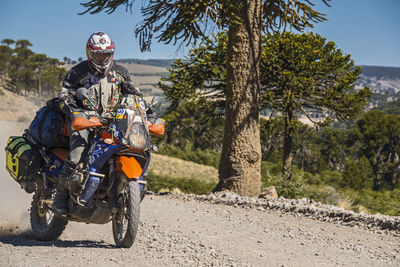 Man on touring motorbikes driving on gravel road in argentina