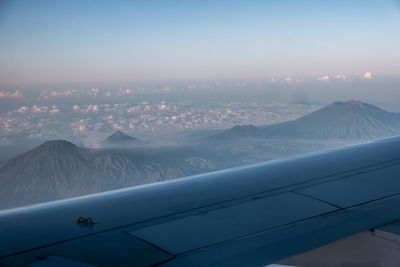 Aerial view of mountains against sky during sunset