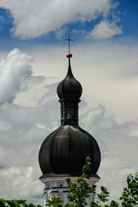 Low angle view of building against cloudy sky