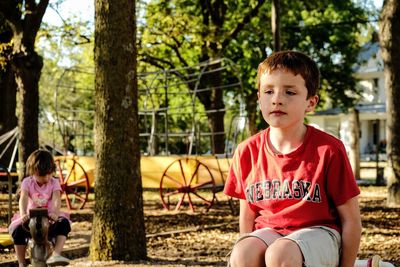 Boy sitting at playground