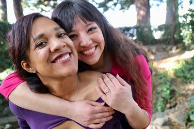 Portrait of sisters embracing at park