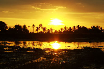 Scenic view of lake against sky during sunset