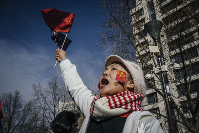 Low angle view of people against sky