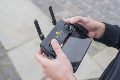 Man controls the remote control from a flying drone of modern technology