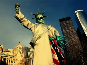 Low angle view of man dresses as statue of liberty