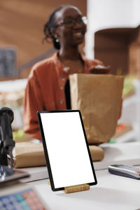 Rear view of man using laptop on table