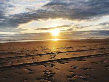 Scenic view of beach against sky during sunset