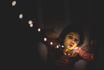 Close-up of illuminated boy at home