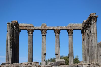 Low angle view of old ruin building against blue sky