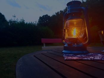 Close-up of lantern on table against sky