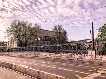 Railroad tracks in city against sky