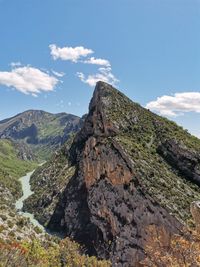 Low angle view of rocks on mountain against sky