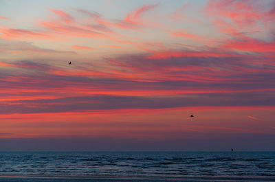 Scenic view of sea against orange sky