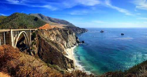 Bixby creek bridge by sea against sky