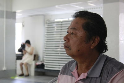 Close-up of man looking away in corridor