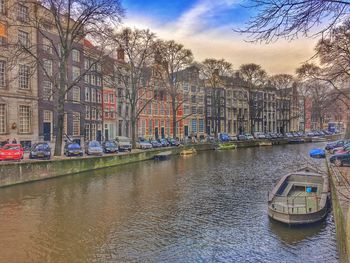 Boats in canal along buildings