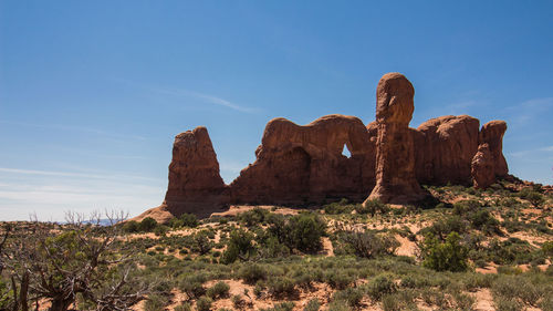 Rock formations on landscape against sky