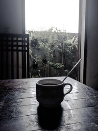 Potted plant on table against window