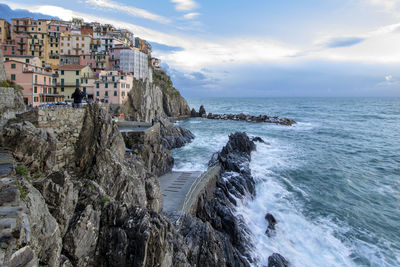 Panoramic view of sea and buildings against sky