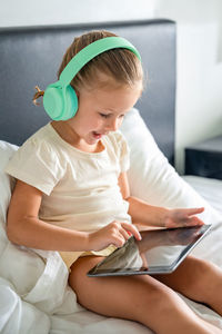 Portrait of cute girl using laptop at home