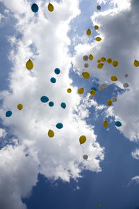 Low angle view of balloons against sky