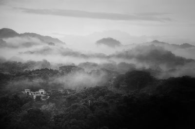 Scenic view of mountains against cloudy sky