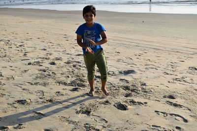 Full length portrait of man standing on beach