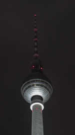 Low angle view of illuminated tower against sky at night