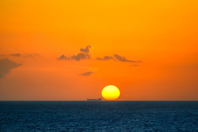 Scenic view of sea against orange sky