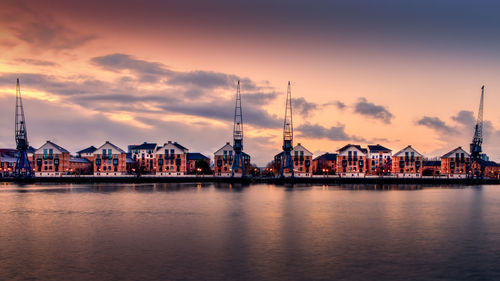 Pier by sea against sky during sunset