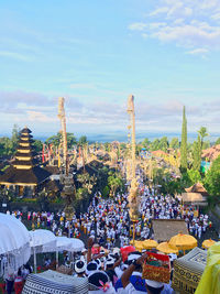 People at town square against sky in city