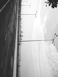 Electricity pylons on landscape against sky