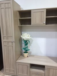 White flower vase on table by window at home