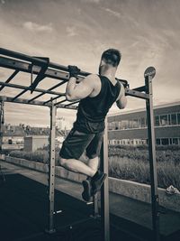 Full length of man standing by railing against sky