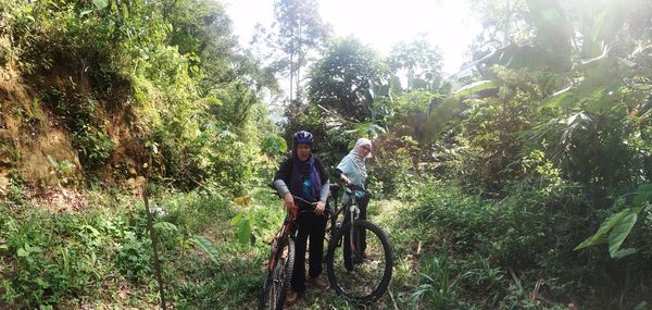 People riding bicycle in forest