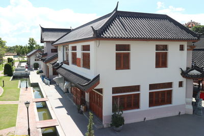 Residential buildings in town against sky