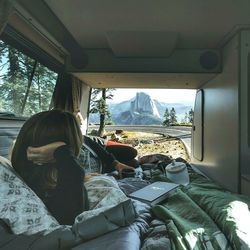 Rear view of woman sitting in bus