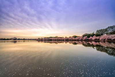 Scenic view of lake against sky at sunset