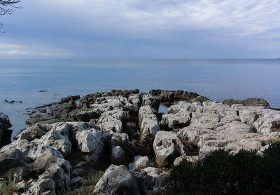 View of calm sea against cloudy sky