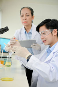 Portrait of female doctor examining patient at clinic