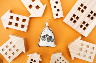 Money bag and many wooden house. real estate investment concept. business and finance.