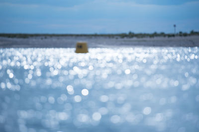 Close-up of sea water on land against sky