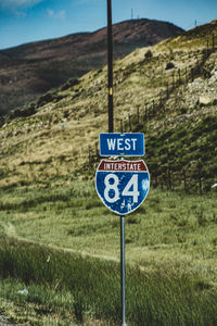 Road sign on field